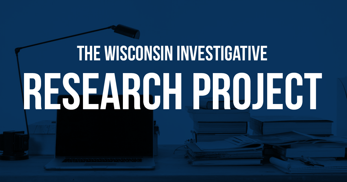 the wisconsin investigative research project over desk and lamp